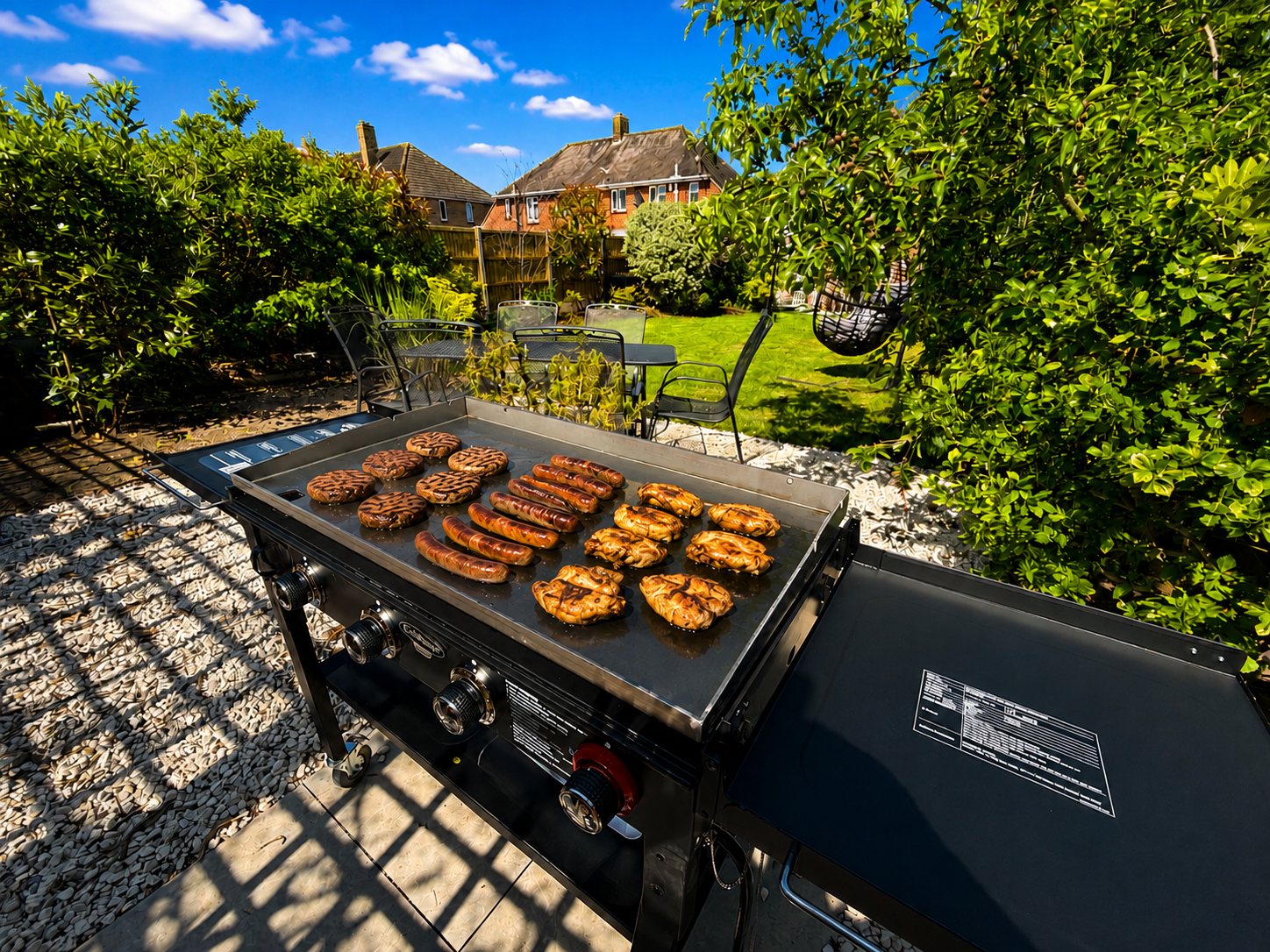 Large outdoor gas griddle being used for relaxed garden cooking