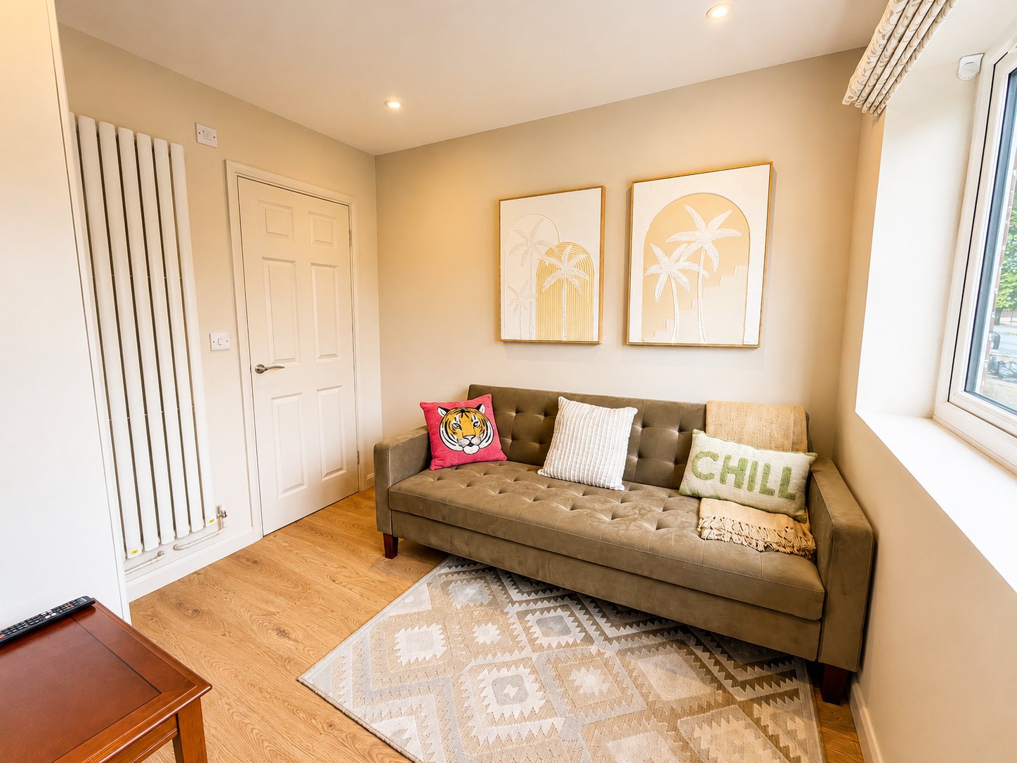 Ground-floor room with sofa bed, TV and warm neutral styling